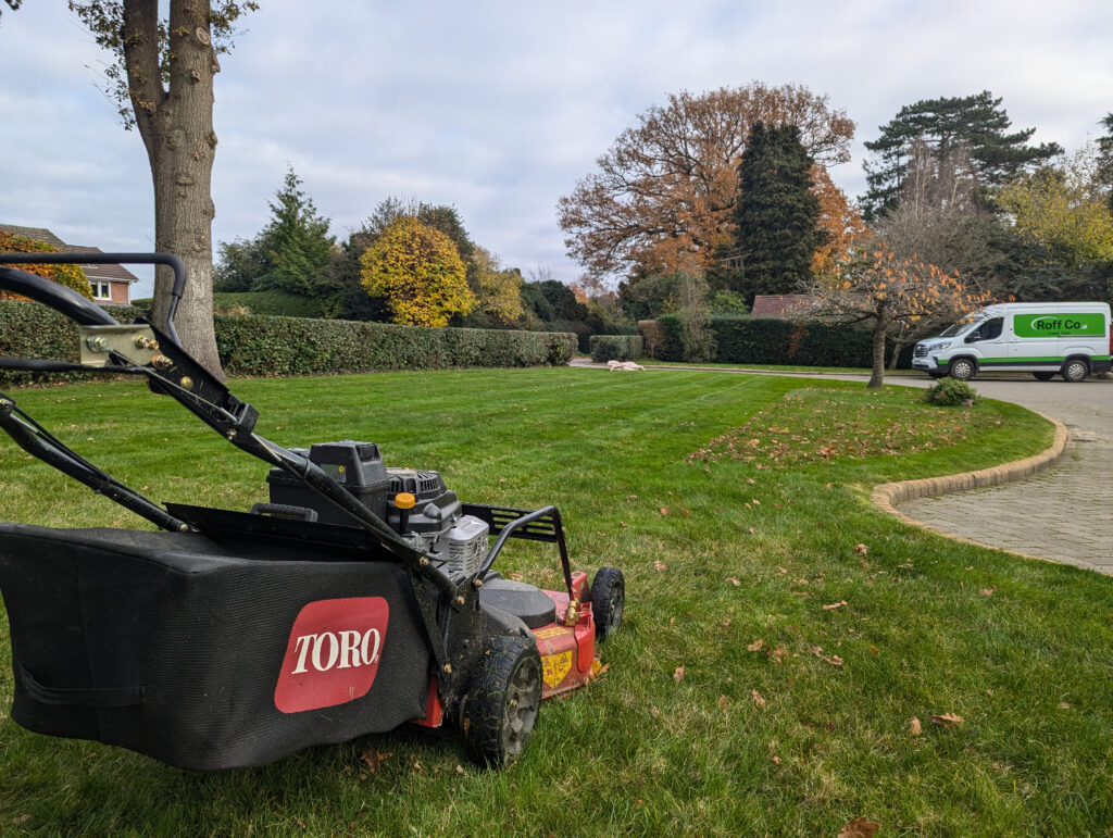 toro lawn mower on lawn with roff co van in driveway